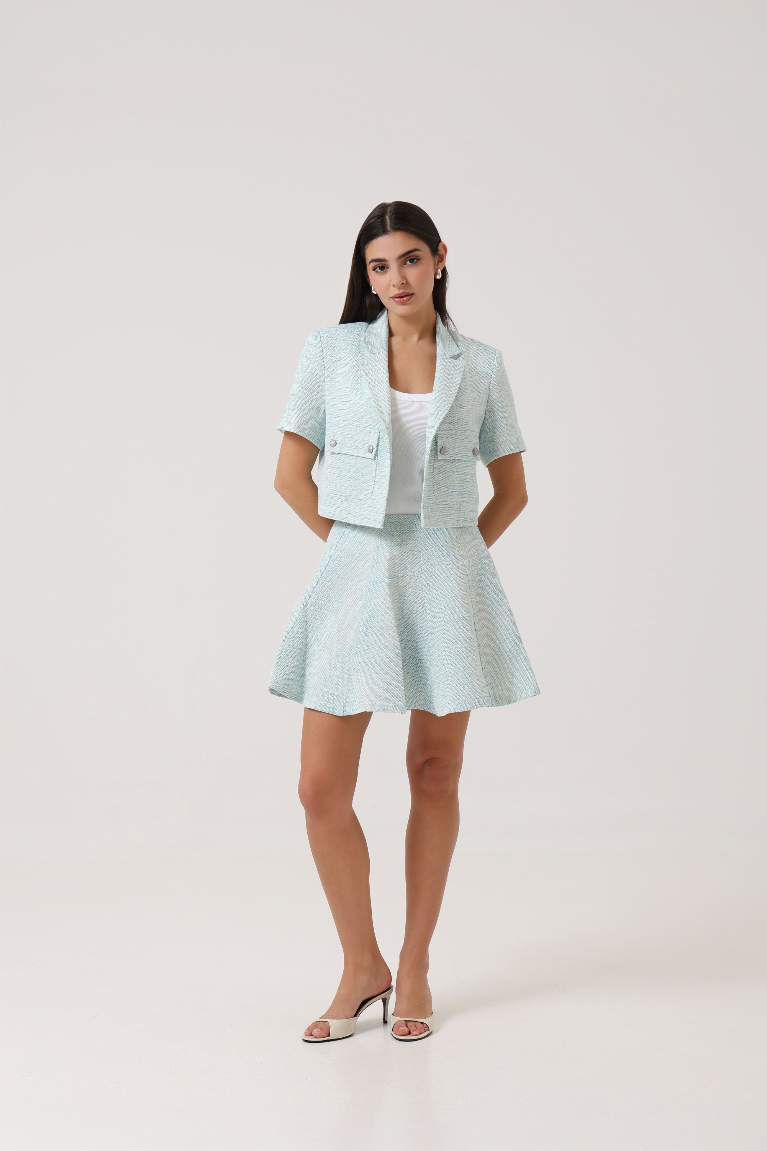 Model posing wearing the Portofino Mare Skirt by Rèmy Suits