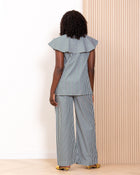 Back view of navy stripe co-ord set by Kras the Label showing wide-leg trousers and ruffle collar top