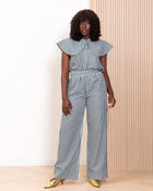 Model wearing navy stripe co-ord set with ruffle collar top and wide-leg trousers by Kras the Label