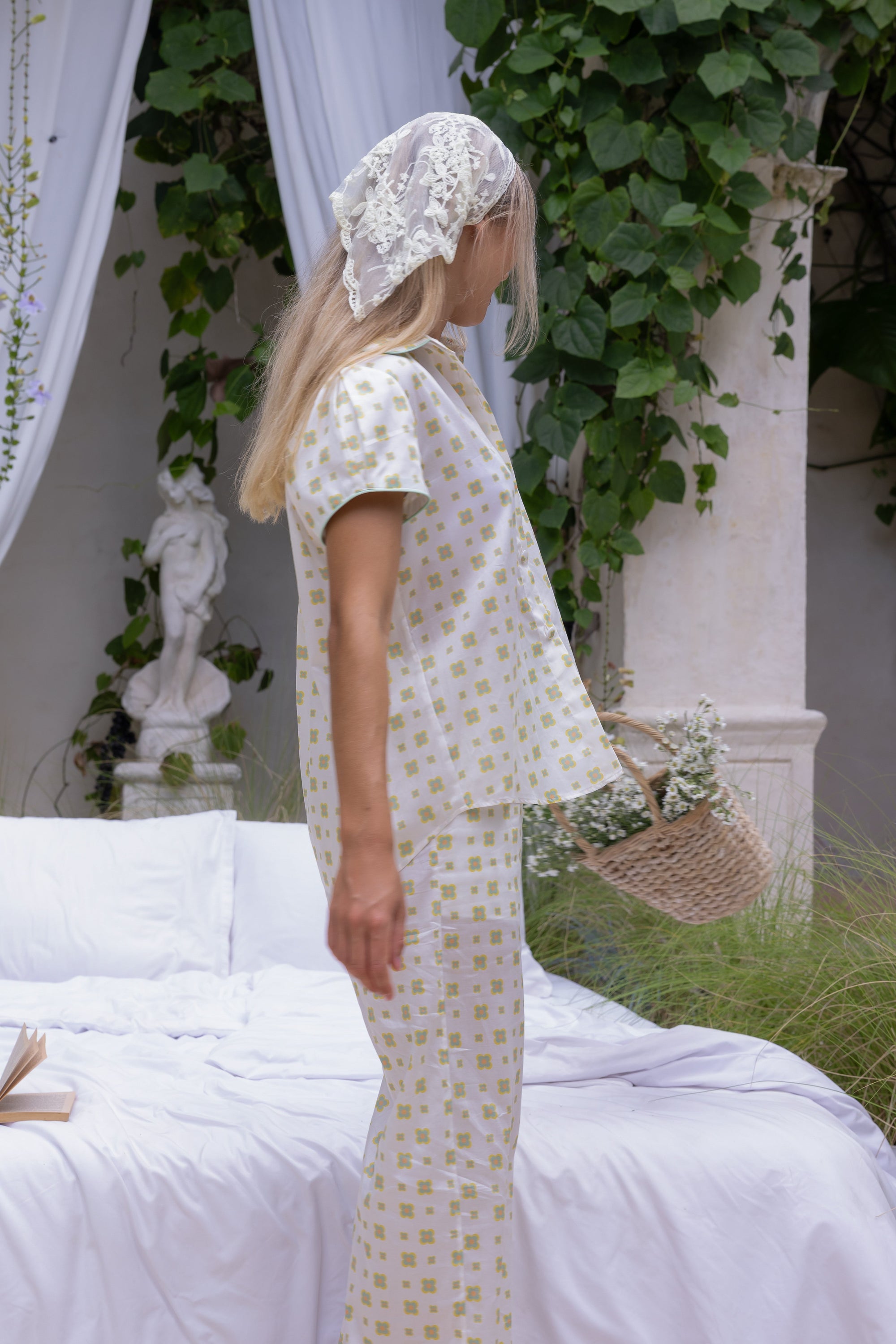 Side view of the Love Letters x Yasmina Pyjama Set with an ivory floral print, short-sleeve shirt and wide-leg trousers.
