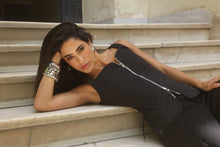 Model posing on the stairs wearing the Edge top by Haïa 