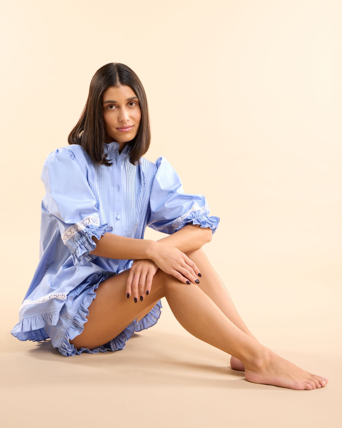 Model seated in the Alma Bluebelle Set, a pretty blue cotton pyjama set for bridal mornings and lazy weekends