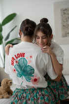 Close-up of the back floral graphic on the EOS x Rémy Bloom oversized white cotton T-shirt