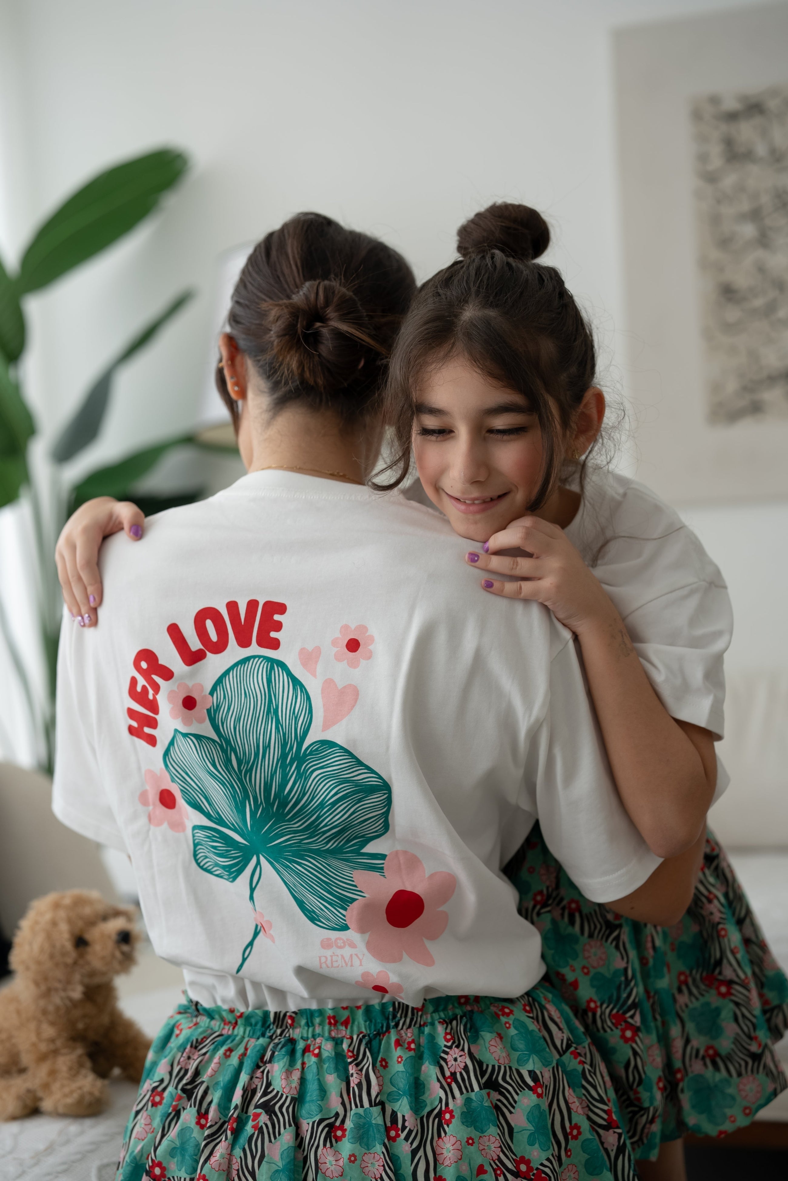 Close-up of the back floral graphic on the EOS x Rémy Bloom oversized white cotton T-shirt