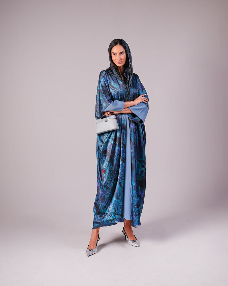 Full-length front view of the sea blue patterned abaya with matching headscarf.