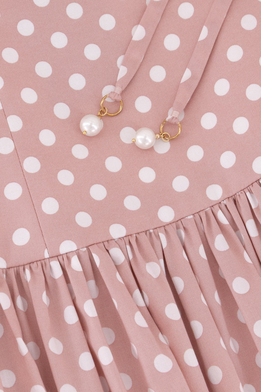 Close-up of the Hazar Azhari Polka Dot Tie Strap Maxi Dress showing the pearl-detailed shoulder straps and gathered skirt.