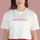 Person wearing a white crop top with 'MOVE BOLDLY' text on a pink background