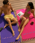 Models posing with Rio Embroidered Turkish Beach Towel in vibrant colours by Ashia

