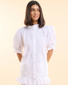 Front view of the Alma Gardenia Set, white button-down pyjama top with frilled cuffs and matching frilled shorts