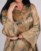 Close-up of Mirelle olive and gold silk dress showing its print and front button detail