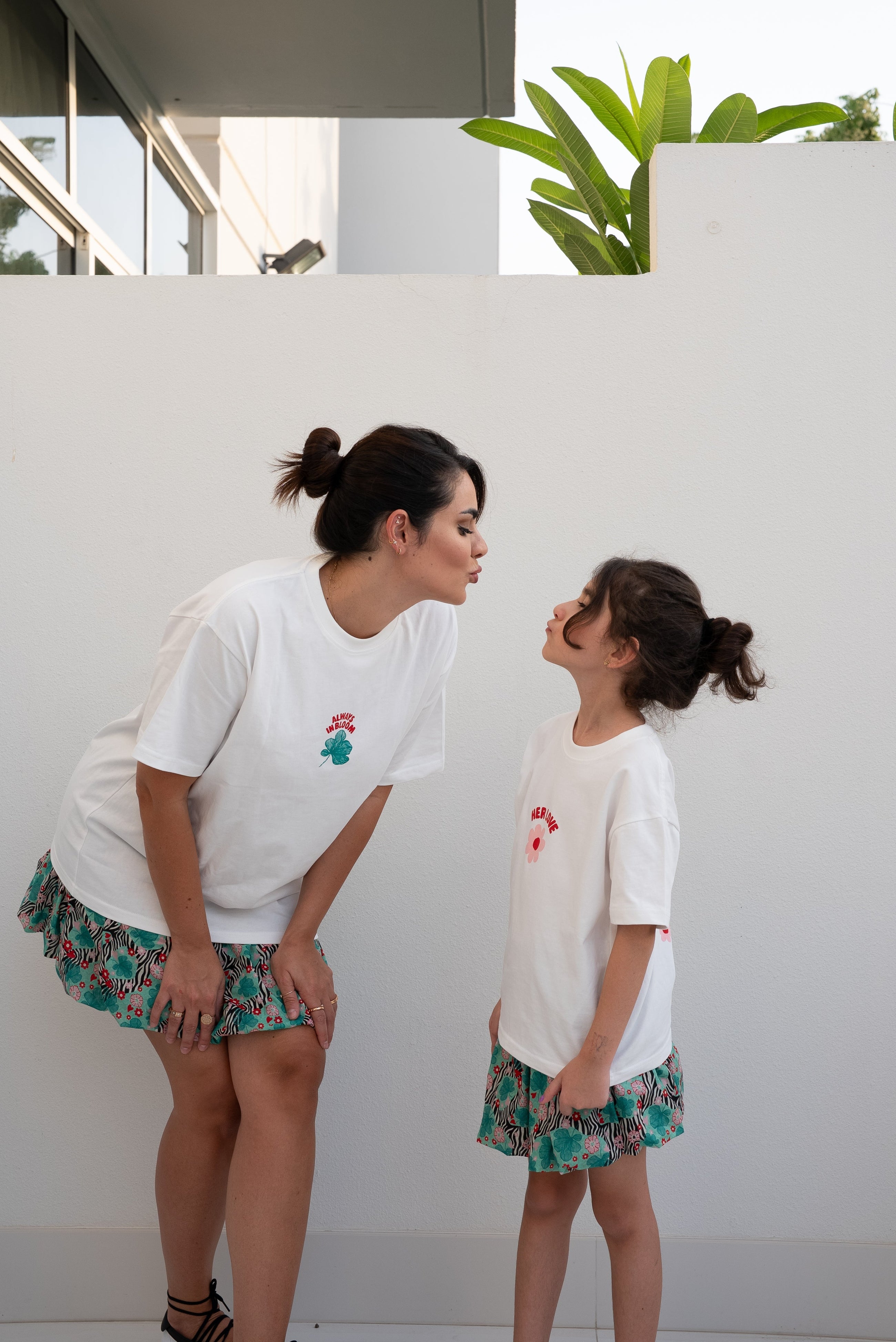 Woman and child wearing the EOS x Rémy Bloom oversized white cotton T-shirt in an oversized unisex fit.