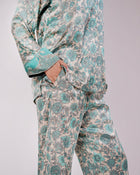 Detail of the Soleia aqua blue silk set showing the top, trousers and coordinated trim
