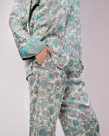 Detail of the Soleia aqua blue silk set showing the top, trousers and coordinated trim