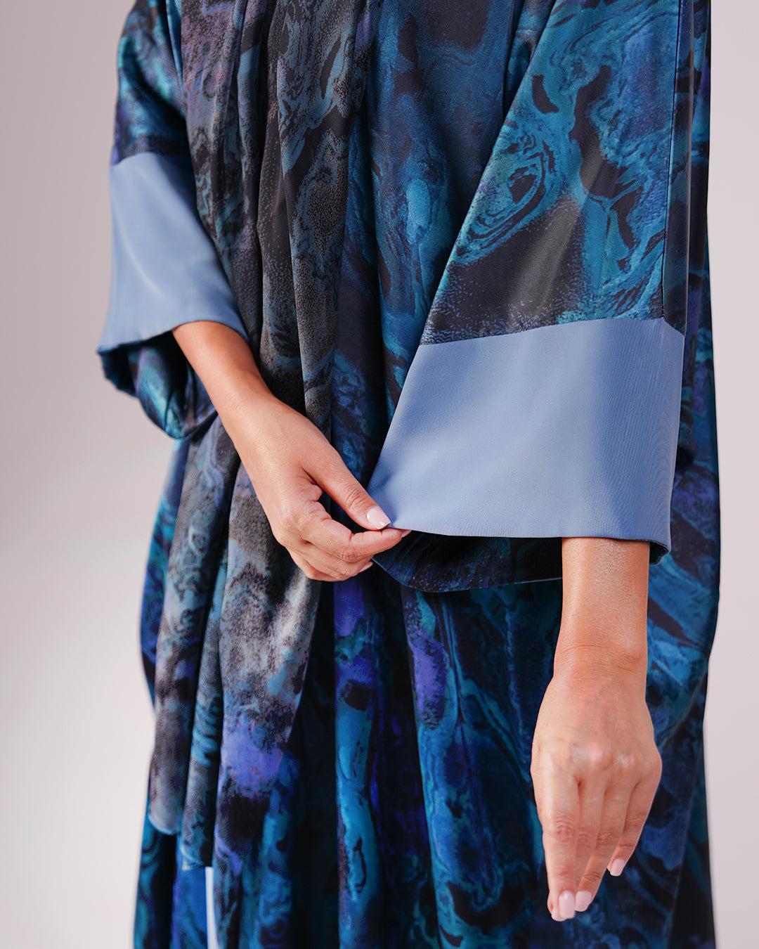 Close-up of the sea blue print and contrasting pale blue sleeve cuff.