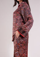 Close-up of the Soleia Rouge silk set showing its printed trousers and pocket