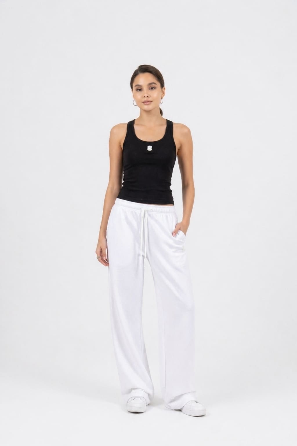 Model wearing the EOS X Remy White Joggers and Black Tank Top 