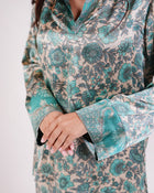 Close-up of the Soleia aqua blue and ivory print and sleeve cuff