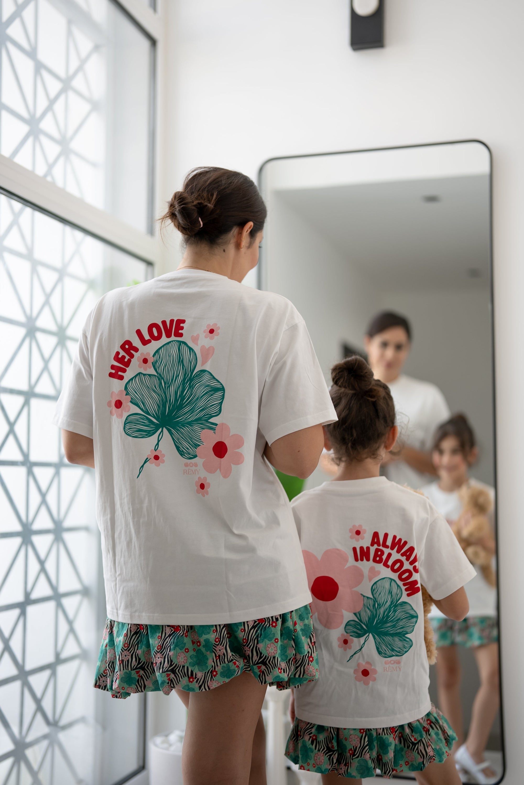 Back view of the EOS x Remy Bloom oversized white cotton T-shirt featuring the large floral graphic print