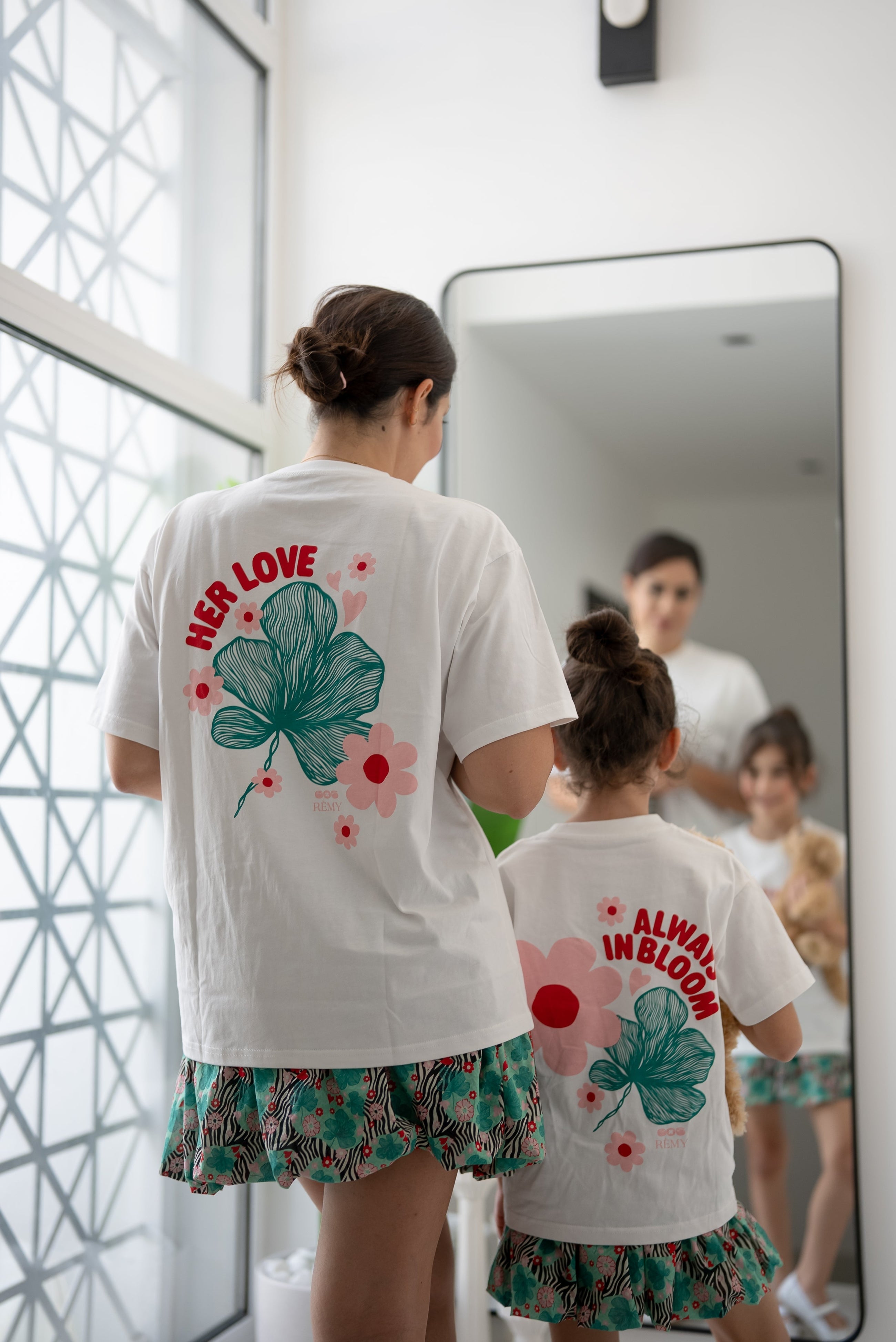 Back view of the EOS x Remy Bloom oversized white cotton T-shirt featuring the large floral graphic print