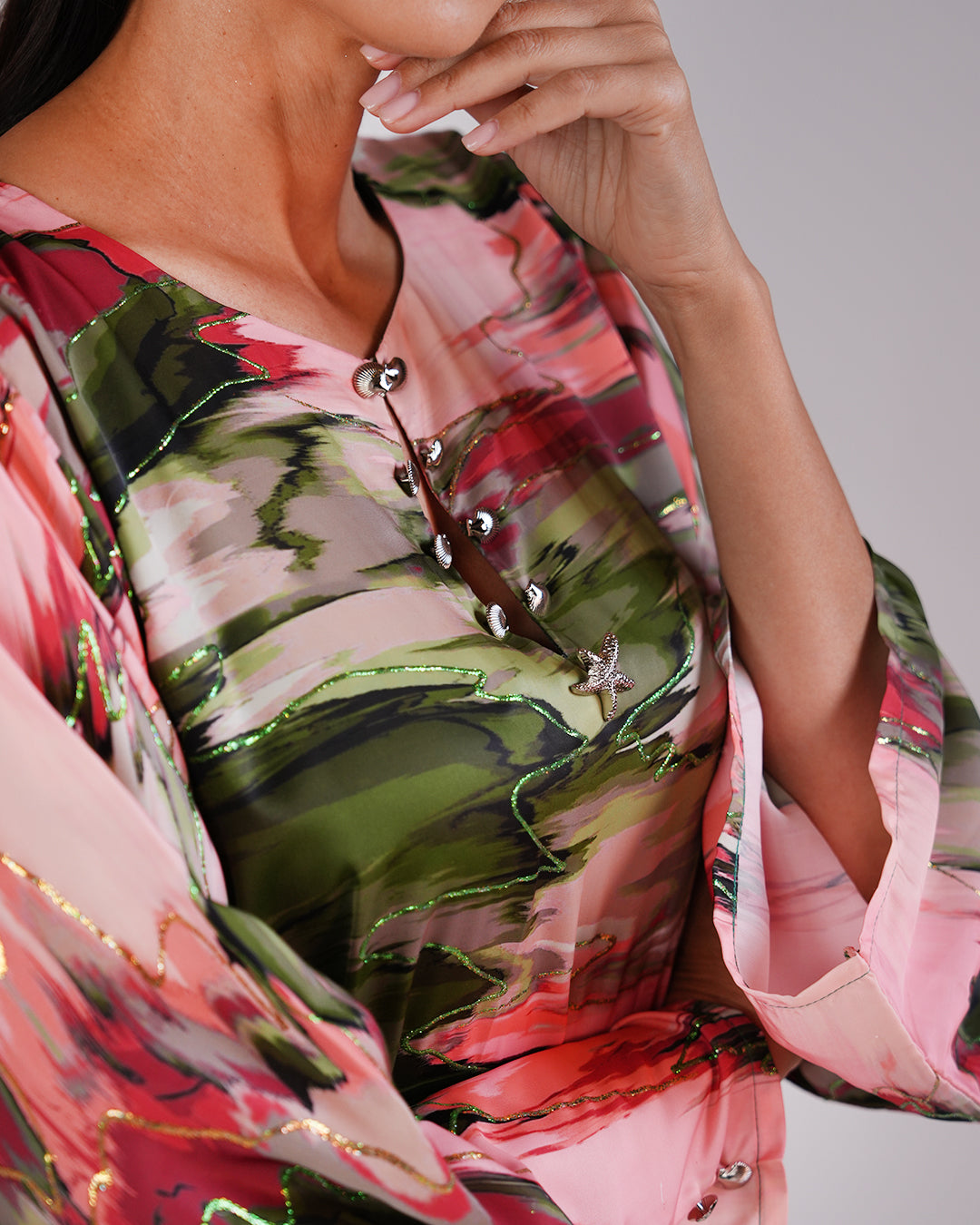 Close-up of the Blossom Garden dress’s pink and green printed fabric.