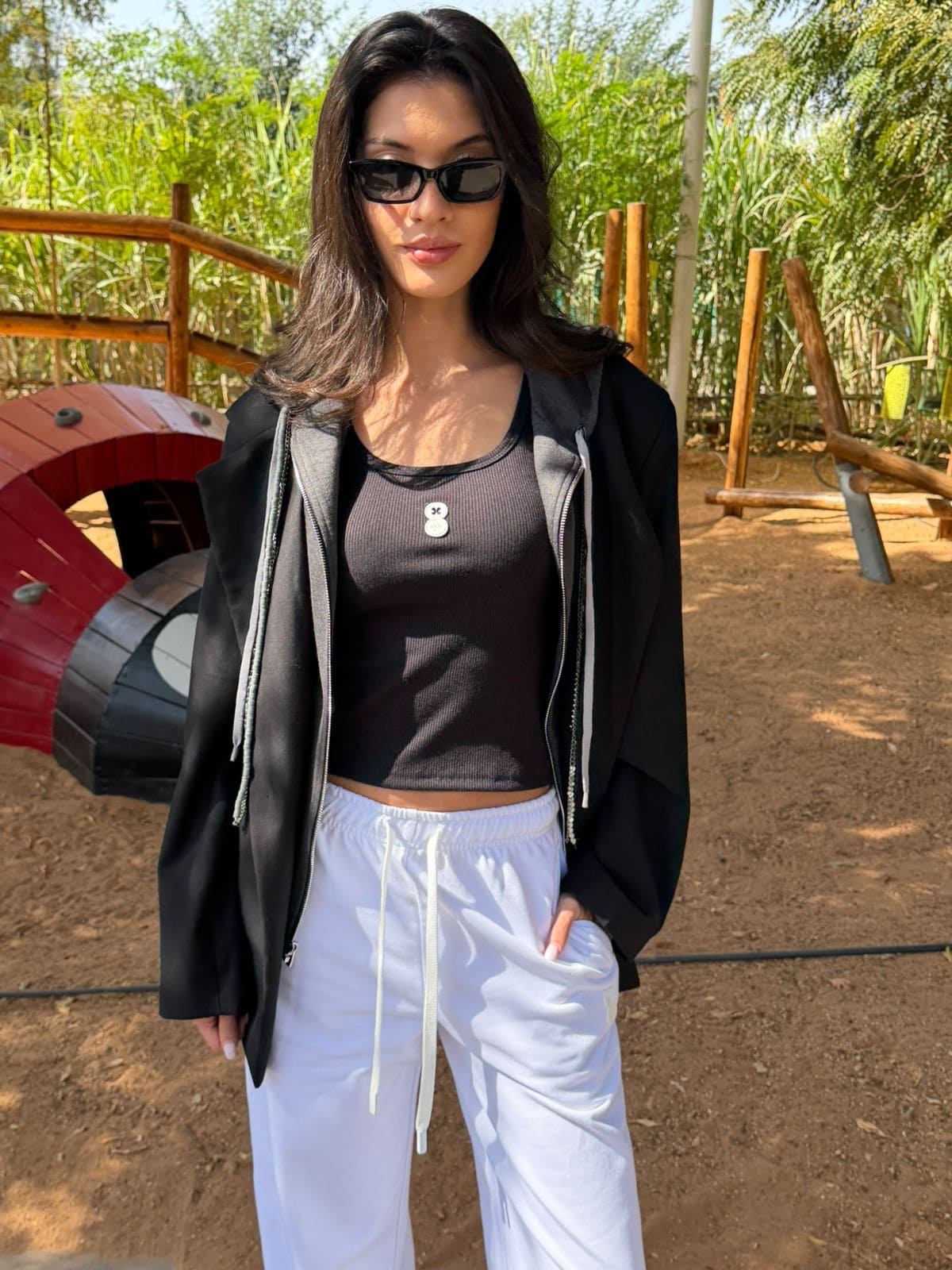 Model posing at the park wearing the EOS x Remy Ribbed Tank Top