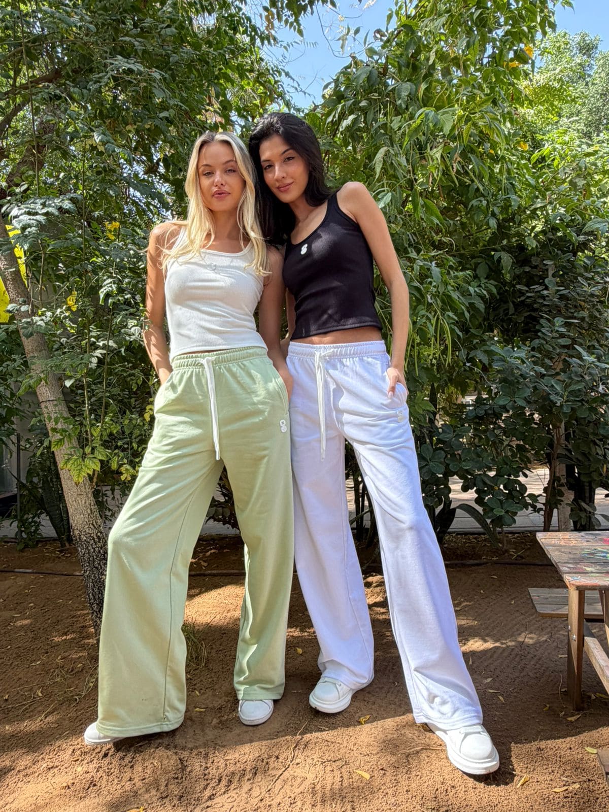 Models wearing the EOS X Remy Joggers in pistachio and white