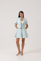 Model wearing the Portofino Mare Jacket and Skirt by Rèmy Suits