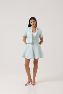 Model wearing the Portofino Mare Jacket and Skirt by Rèmy Suits