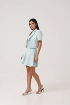 Side profile of model wearing the Portofino Mare Skirt by Rèmy Suits