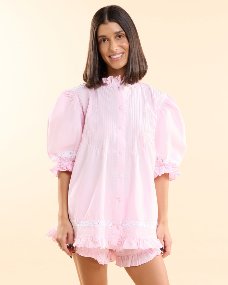 Front view of the Alma Blossom Set, pink cotton button-down pyjama top with pin-tuck pleats and matching frilled shorts
