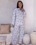 Layla Blue Long PJ Set – front-facing full-length view of model standing and smiling in pale blue long pyjama set with pink leopard print, button-down shirt and wide-leg trousers