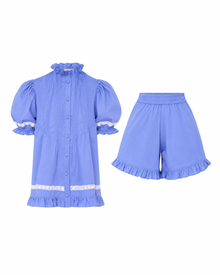 Alma Bluebelle Set flat lay: periwinkle blue frilled collar top and matching frilled shorts with white trim