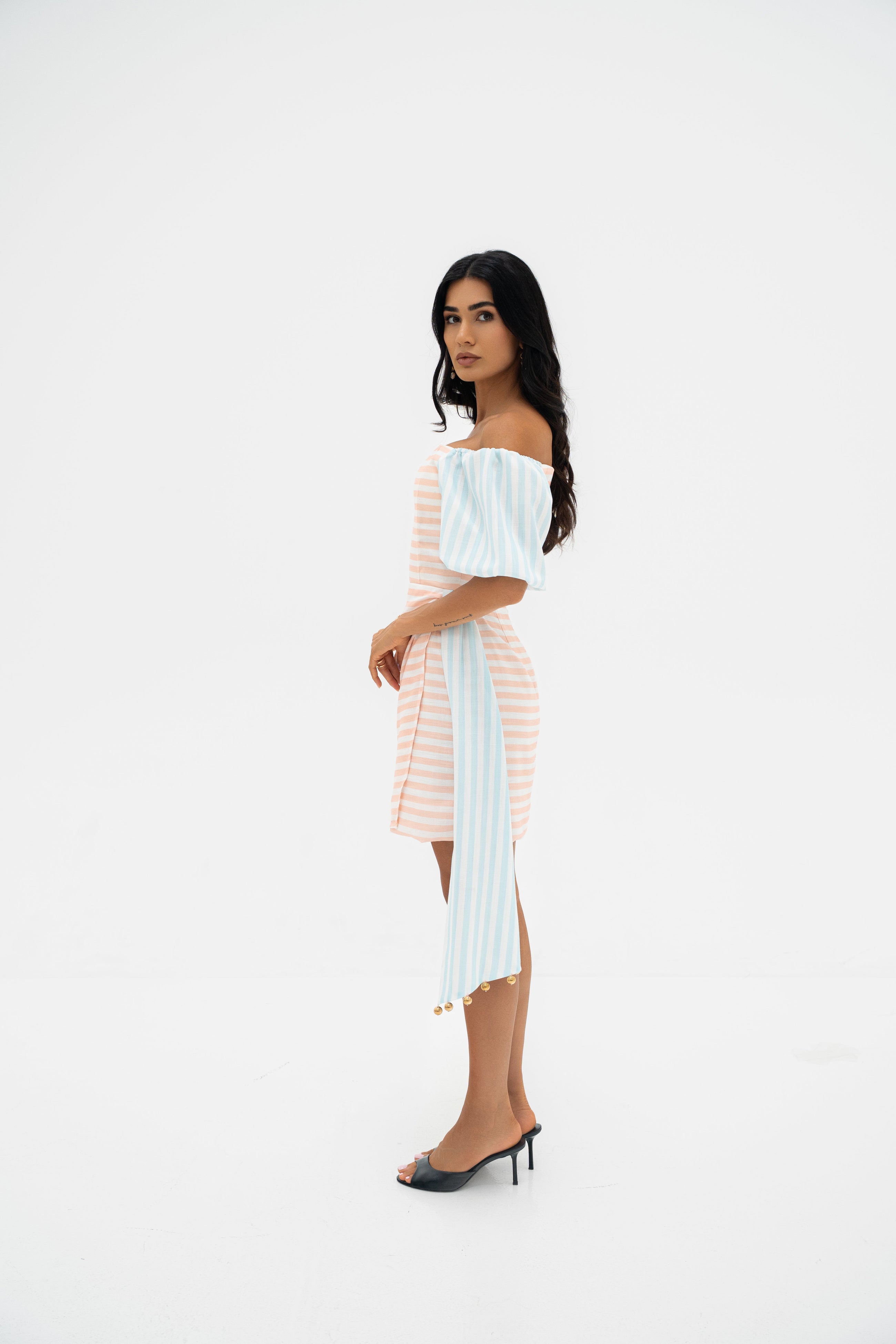 Side profile of model wearing the Azelia dress by Ragimora