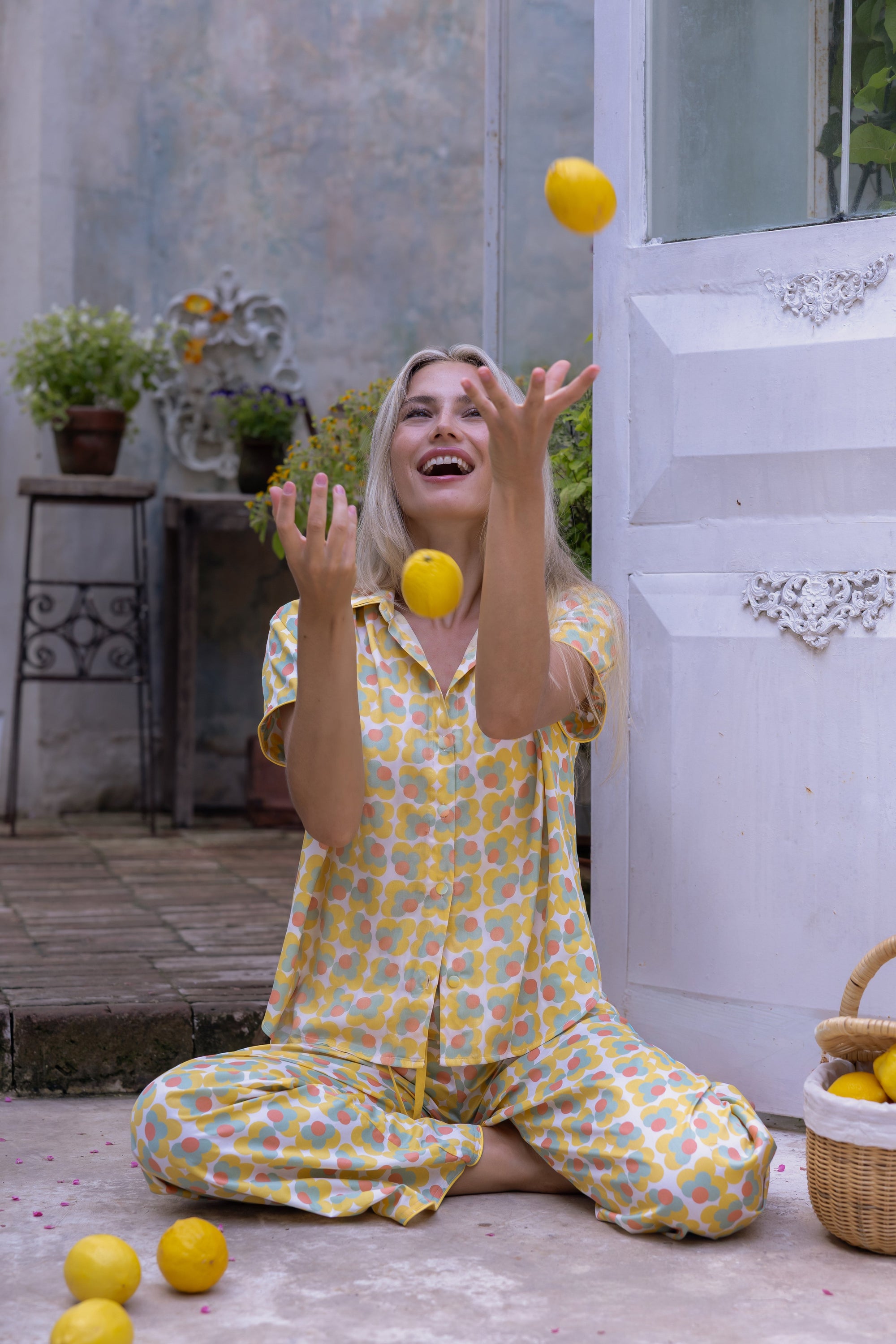 Model wearing the Love Letters x Nour Pyjama Set with a yellow floral print and wide-leg trousers.