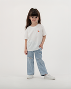 Child dressed in white Batikh Watermelon Print T-Shirt with playful fruit design.