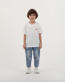 Boy wearing white Batikh Watermelon Print Kids T-Shirt with fruit design on back.