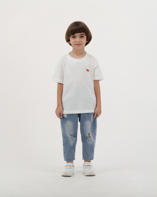 Boy wearing white Batikh Watermelon Print Kids T-Shirt with fruit design on back.