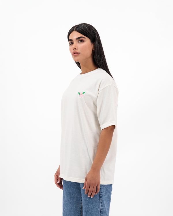 Woman wearing Jasmine White Oversized T-Shirt with floral pink print on back.