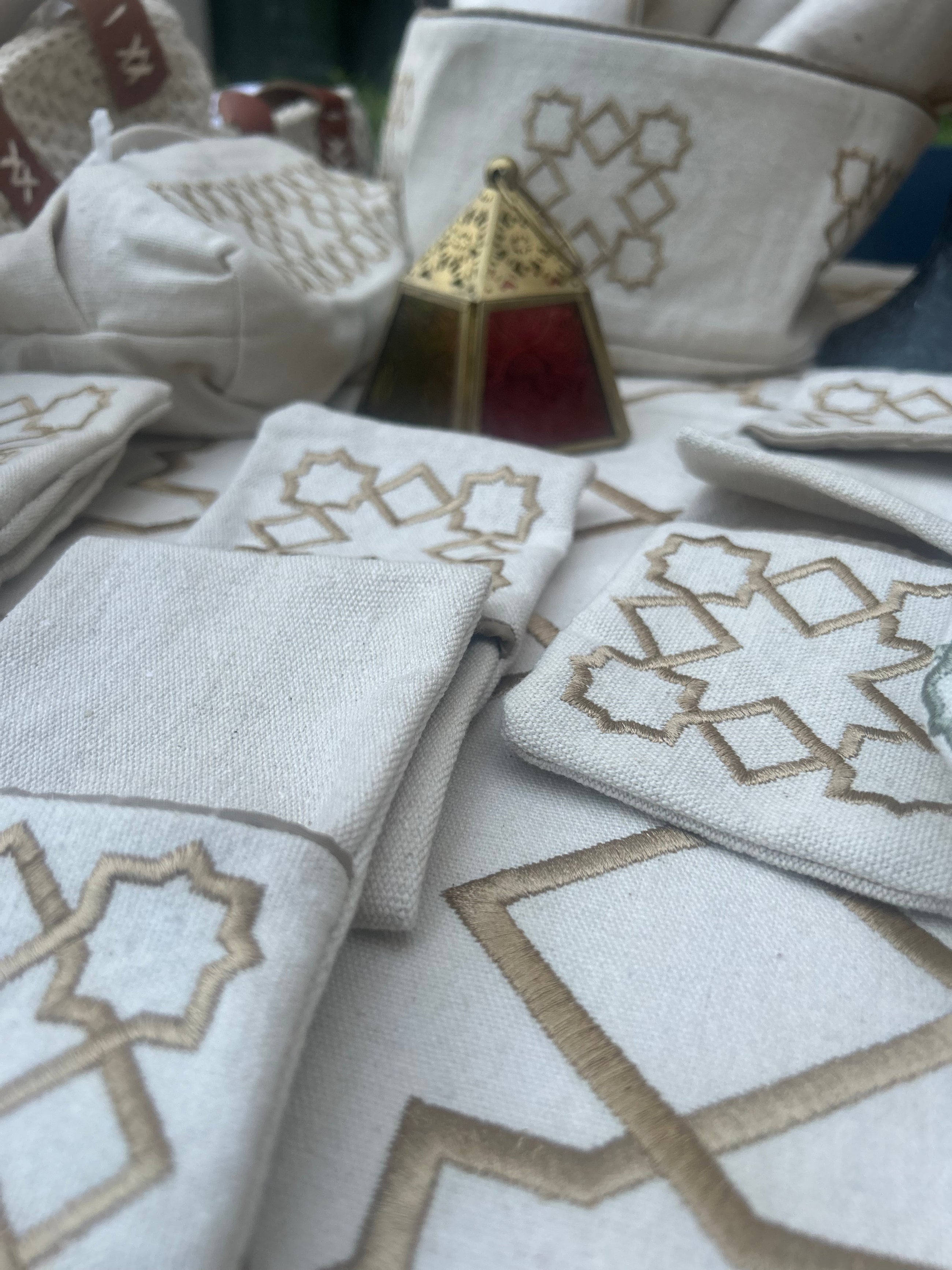 The Arabesque Table Set - 15 Piece Bronze Embroidered set from Raw Cotton placed in a handmade basket with leather handles. 