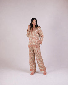 Full-length view of the Soleia peach and nude top with wide-leg trousers