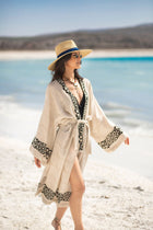Model walking on the beach wearing the Gaia Kimono by Zerla Studio