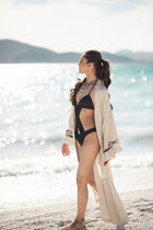 Model walking on the beach wearing the Delphi Kimono by Zerla Studio
