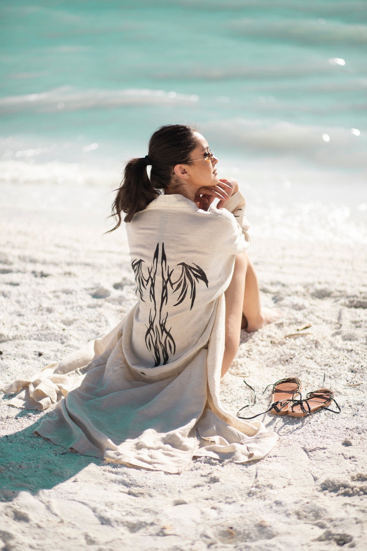 Model posing while sitting down, wearing the Delphi Kimono
