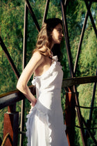 Side view of the model wearing the Hazar Azhari Halter Neck Cascading Ruffle Maxi Dress.