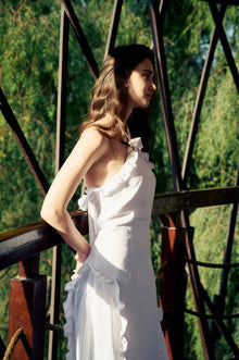 Side view of the model wearing the Hazar Azhari Halter Neck Cascading Ruffle Maxi Dress.