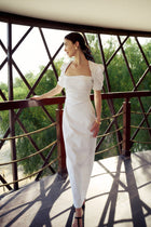 Model wearing the Curved Seam Puff Sleeve Maxi Dress by Hazar Azhari 