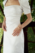 Close-up detail shot of the Curved Seam Puff Sleeve Maxi Dress